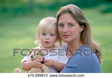 Stock Image - mom, her daughter and teddy bear. Fotosearch