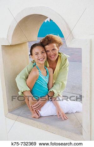 Mom hugging her pre-teen daughter View Large Photo Image Stock Photo - Mom hugging her pre-teen daughter. Fotosearch