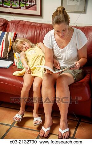 Mom reads aloud to her apparently bored daughter at home in Laguna Niguel, CA. View Large Photo Image Stock Image - Mom reads aloud to her apparently bored daughter at home in Laguna Niguel, CA.. Fotosearch