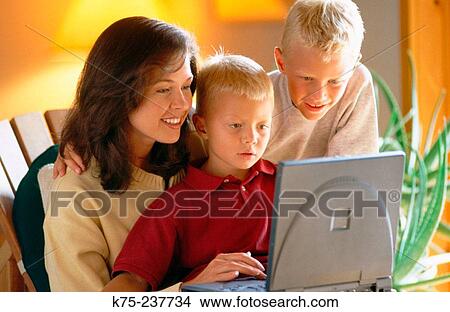 mom using laptop with her sons View Large Photo Image Picture - mom using laptop with her sons. Fotosearch