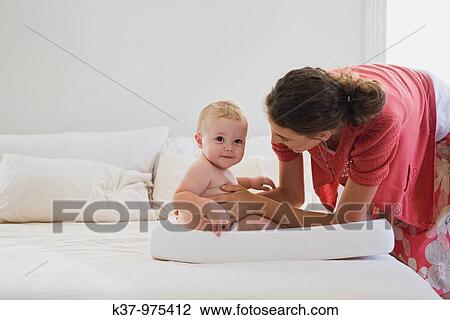 Stock Image - Mom with baby wearing cloth diaper MR0904 MR0906 PR0911. Fotosearch