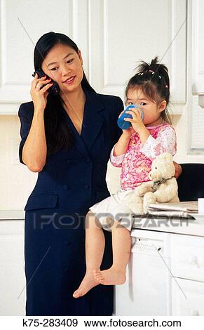 Mom with her daughter before going to work View Large Photo Image Stock Photo - Mom with her daughter before going to work. Fotosearch