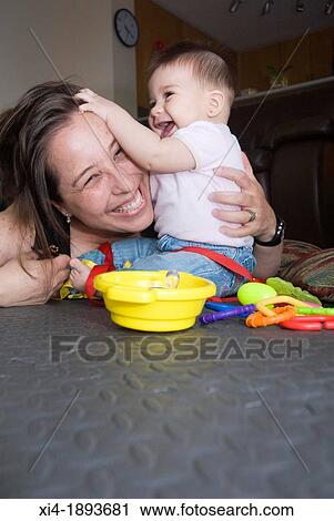 Mommy and baby playing in the floor View Large Photo Image Stock Image - Mommy and baby playing in the floor. Fotosearch