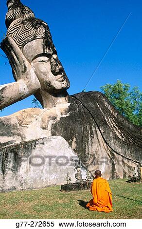 Monk at the giant Buddha, Buddha Park. Vientiane. Laos View Large Photo Image Stock Photography - Monk at the giant Buddha, Buddha Park. Vientiane. Laos. Fotosearch