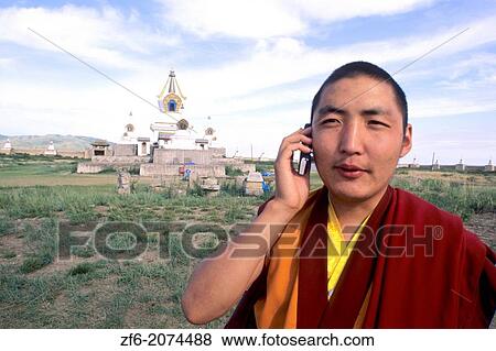 Monk Near Sacred Stupas on Cell Phone at Erdene Zuu Monastery 1586 in Mongolia. View Large Photo Image Stock Photo - Monk Near Sacred Stupas on Cell Phone at Erdene Zuu Monastery 1586 in Mongolia.. Fotosearch