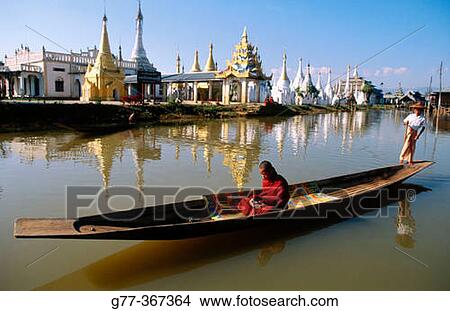 Monk on boat for alms. Inle Lake. Shan State. Myanmar. View Large Photo Image Picture - Monk on boat for alms. Inle Lake. Shan State. Myanmar.. Fotosearch
