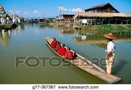 Monk on boat for alms. Inle Lake. Shan State. Myanmar. View Large Photo Image Stock Photo - Monk on boat for alms. Inle Lake. Shan State. Myanmar.. Fotosearch