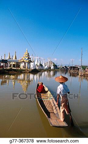 Monk on boat for alms. Inle Lake. Shan State. Myanmar. View Large Photo Image Stock Photo - Monk on boat for alms. Inle Lake. Shan State. Myanmar.. Fotosearch