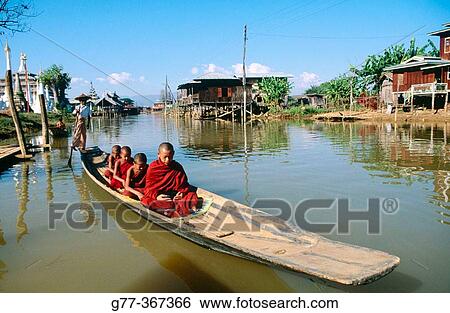 Monk on boat for alms. Inle Lake. Shan State. Myanmar. View Large Photo Image Stock Photograph - Monk on boat for alms. Inle Lake. Shan State. Myanmar.. Fotosearch