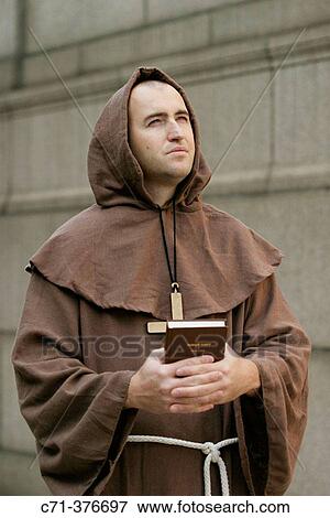 Monk. Priest holding Bible. View Large Photo Image Stock Photo - Monk. Priest holding Bible.. Fotosearch