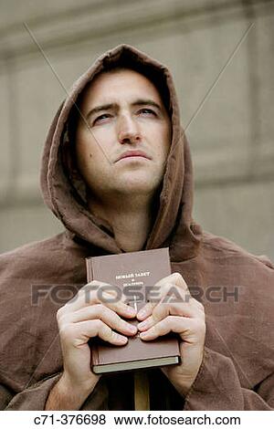 Monk. Priest holding Bible. View Large Photo Image Stock Photo - Monk. Priest holding Bible.. Fotosearch