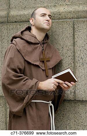 Monk. Priest holding Bible. View Large Photo Image Stock Photo - Monk. Priest holding Bible.. Fotosearch