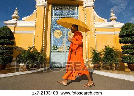 Monk walk outside the Royal Palace. Phnom Penh. The Royal Palace of Cambodia is a complex of buildings View Large Photo Image Stock Photo - Monk walk outside the Royal Palace. Phnom Penh. The Royal Palace of Cambodia is a complex of buildings. Fotosearch