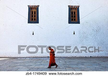 Stock Photo - Monk walking inside Punakha Dzong, Punakha, Bhutan, Asia.. Fotosearch