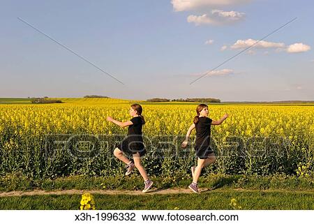 montage, little girl running in blossoming fields of rapeseed, Senantes, Eure-et-Loir department, Centre region, France, Europe. View Large Photo Image Stock Image - montage, little girl running in blossoming fields of rapeseed, Senantes, Eure-et-Loir department, Centre region, France, Europe.. Fotosearch