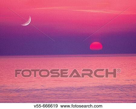 Stock Photo - Moon and setting sun over Straits of Juan De Fuca, from San Juan Island, Washington State, USA.. Fotosearch