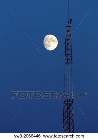 Stock Photograph - Moon over telecommunications tower, Iceland.. Fotosearch