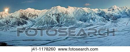 Moon setting behind Ben Ohau mountains, pre-dawn light, panorama of Tasman river flats to Mount Sefton from Burnett Mountains, Mount Cook National Park. View Large Photo Image Stock Image - Moon setting behind Ben Ohau mountains, pre-dawn light, panorama of Tasman river flats to Mount Sefton from Burnett Mountains, Mount Cook National Park.. Fotosearch