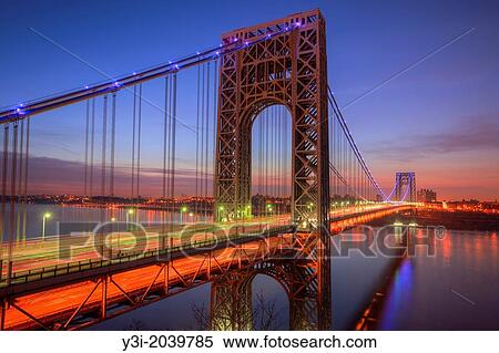 Morning rush hour traffic creates streaks of light on the George Washington Bridge as commuters cross the Hudson River between Fort Lee, New Jersey and Fort Washington, New York before sunrise on April 8, 2013. View Large Photo Image Stock Photography - Morning rush hour traffic creates streaks of light on the George Washington Bridge as commuters cross the Hudson River between Fort Lee, New Jersey and Fort Washington, New York before sunrise on April 8, 2013.. Fotosearch