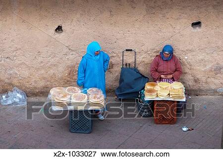 Stock Photo - Moroccan women selling bread next to Sidi Abdelwahab gate, Oujda, Oriental region, Morocco. Fotosearch