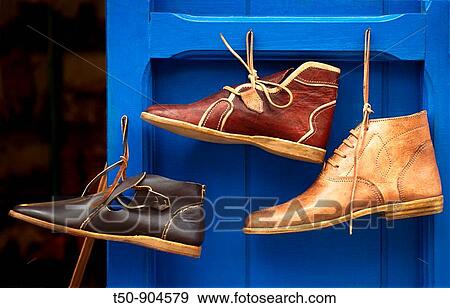 Morocco, Asilah, shoes hanging on blue door View Large Photo Image Stock Photo - Morocco, Asilah, shoes hanging on blue door. Fotosearch