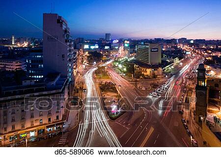 Stock Photograph - Morocco-Casablanca: Place des Nations Unies-Aerial View of Hyatt Hotel & Ancienne Medina Clock Tower / Evening. Fotosearch