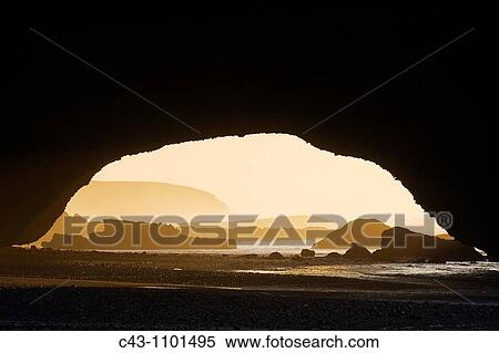 Morocco - Rock arch at the Atlantic Ocean at Legzira beach, 11km north of the town of Sidi Ifni in southwest Morocco View Large Photo Image Stock Photography - Morocco - Rock arch at the Atlantic Ocean at Legzira beach, 11km north of the town of Sidi Ifni in southwest Morocco. Fotosearch