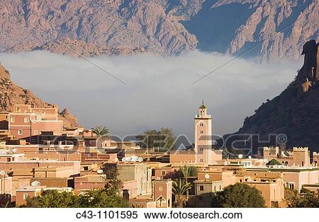 Morocco - The village of Aguard Oudad at the foot of the famous rock formation Chapeau de Napol? on Napole? n's hat In the background the Djebel El Kest and the Ameln valley with early morning mist Ameln valley, Anti-Atlas mountains, Morocco View Large Photo Image Stock Photography - Morocco - The village of Aguard Oudad at the foot of the famous rock formation Chapeau de Napol? on Napole? n's hat In the background the Djebel El Kest and the Ameln valley with early morning mist Ameln valley, Anti-Atlas mountains, Morocco. Fotosearch