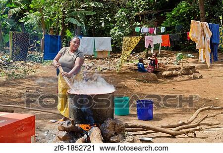 Mosquito Village Mto wa Mbu Tanzania Africa village woman cooking big pot of banana beer for sale to tourists 6 View Large Photo Image Stock Image - Mosquito Village Mto wa Mbu Tanzania Africa village woman cooking big pot of banana beer for sale to tourists 6. Fotosearch