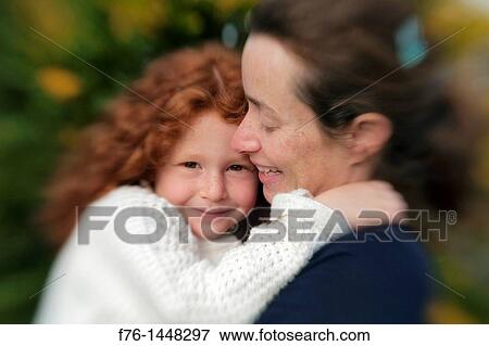 Mother 30s holding her five year old red haired daughter with intentional blur created with Lensbaby, MR 6063 View Large Photo Image Stock Photo - Mother 30s holding her five year old red haired daughter with intentional blur created with Lensbaby, MR 6063. Fotosearch