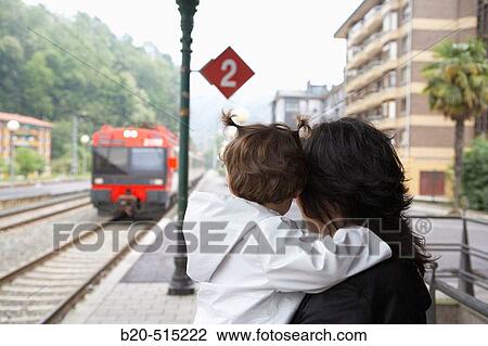 Mother (35 years old) and daughter (2 years old) waiting for the tramway. Railway station. View Large Photo Image Stock Image - Mother (35 years old) and daughter (2 years old) waiting for the tramway. Railway station.. Fotosearch
