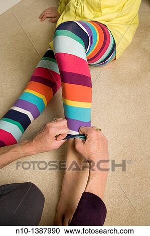 Mother adjusting her daughter's tights View Large Photo Image Stock Image - Mother adjusting her daughter's tights. Fotosearch
