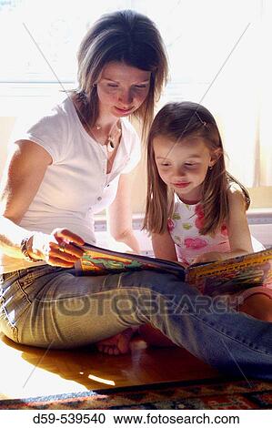 Mother and 4 year old daughter reading a book View Large Photo Image Stock Image - Mother and 4 year old daughter reading a book. Fotosearch