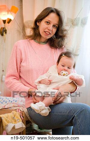 Stock Photo - Mother and 9 months girl. Fotosearch