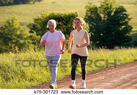 Mother and adult daughter walking View Large Photo Image Stock Image - Mother and adult daughter walking. Fotosearch