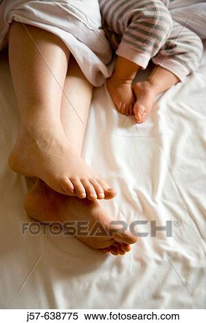 Mother and baby daughter sleeping in bed in hotel. View Large Photo Image Stock Photography - Mother and baby daughter sleeping in bed in hotel.. Fotosearch