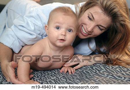 mother and baby on a bed View Large Photo Image Picture - mother and baby on a bed. Fotosearch