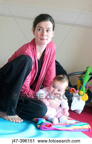Mother and baby sitting on the floor, serious View Large Photo Image Stock Image - Mother and baby sitting on the floor, serious. Fotosearch