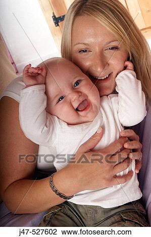 Mother and baby smiling into camera View Large Photo Image Stock Image - Mother and baby smiling into camera. Fotosearch