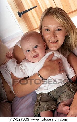 Mother and baby smiling into camera View Large Photo Image Stock Image - Mother and baby smiling into camera. Fotosearch