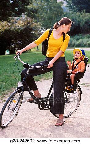 Mother and child in a bicycle View Large Photo Image Stock Image - Mother and child in a bicycle. Fotosearch