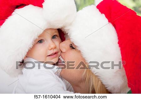 Mother and child wearing Santa hats View Large Photo Image Picture - Mother and child wearing Santa hats. Fotosearch