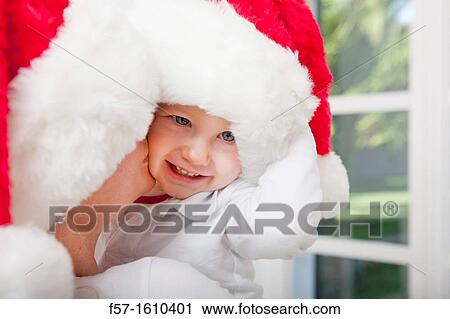 Mother and child wearing Santa hats View Large Photo Image Stock Image - Mother and child wearing Santa hats. Fotosearch