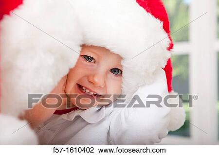 Mother and child wearing Santa hats View Large Photo Image Stock Image - Mother and child wearing Santa hats. Fotosearch