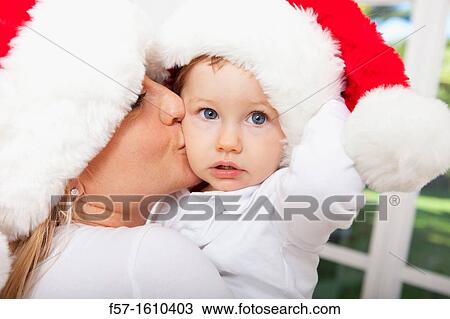 Mother and child wearing Santa hats View Large Photo Image Stock Image - Mother and child wearing Santa hats. Fotosearch