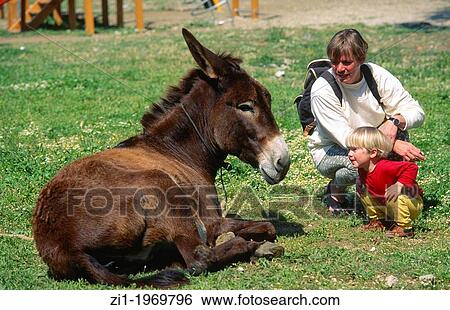 Stock Photograph - mother and child with donkey at Paros, Greece. Fotosearch