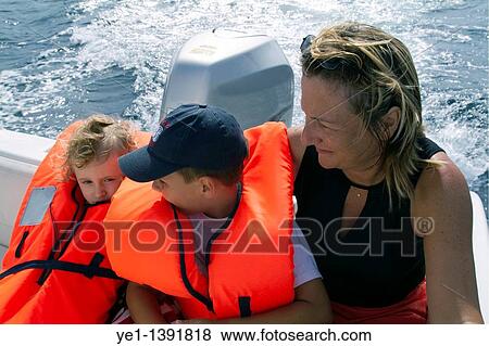 Mother and children wearing life jackets on a boat while on holiday together, La Ciotat, Provence, France View Large Photo Image Stock Photo - Mother and children wearing life jackets on a boat while on holiday together, La Ciotat, Provence, France. Fotosearch