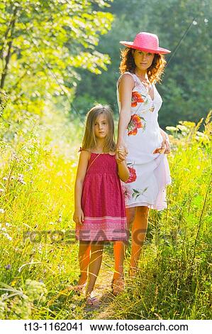 Mother and daughter are walking in the woods View Large Photo Image Stock Image - Mother and daughter are walking in the woods. Fotosearch