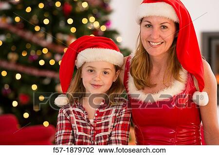 Stock Image - Mother and daughter at Christmas time. Fotosearch
