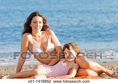 Mother and daughter enjoying a day at the beach View Large Photo Image Stock Image - Mother and daughter enjoying a day at the beach. Fotosearch